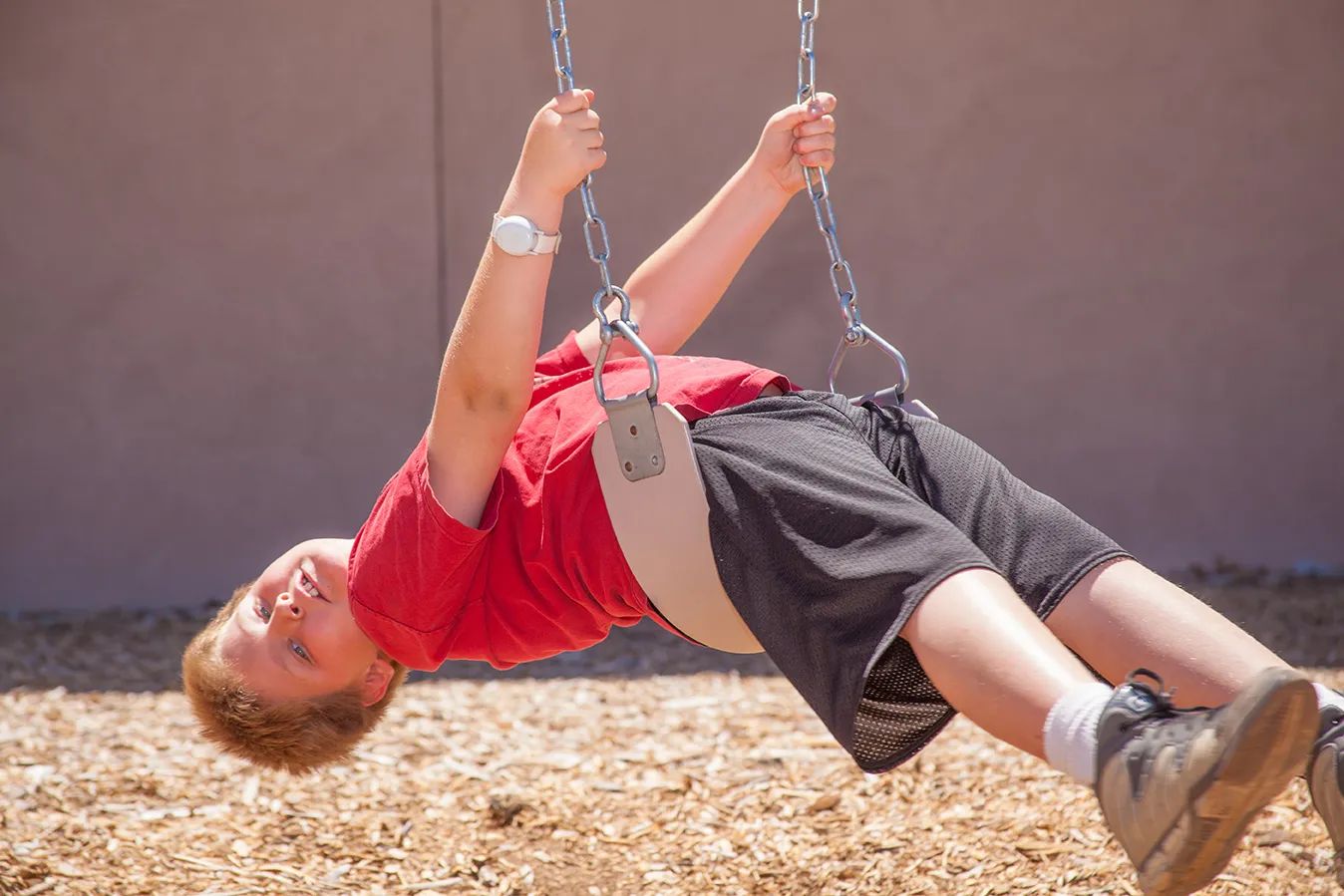 A student enjoying the playground on a sunny Arizona afternoon